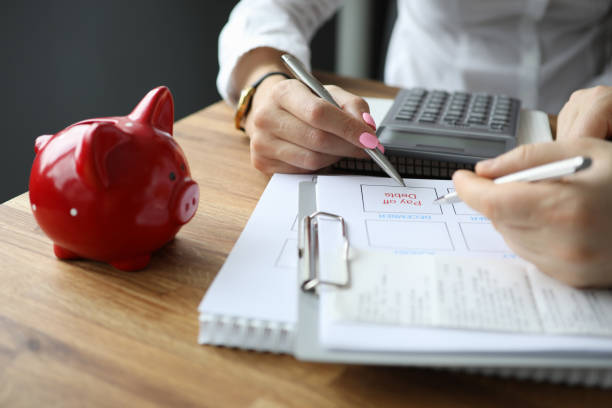 istock Pay off debts lies on table next to piggy bank 1223089344