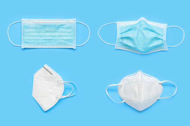 istock KN95 and surgical face mask on blue background protection against pm 2.5 polution and COVID-19 coronavirus. Healthcare and medical concept 1223089431