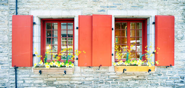 Panoramic view of windows with red dormers and Spring Flowers