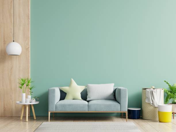 istock Empty living room with blue sofa, plants and table on empty green wall background. 1223090546