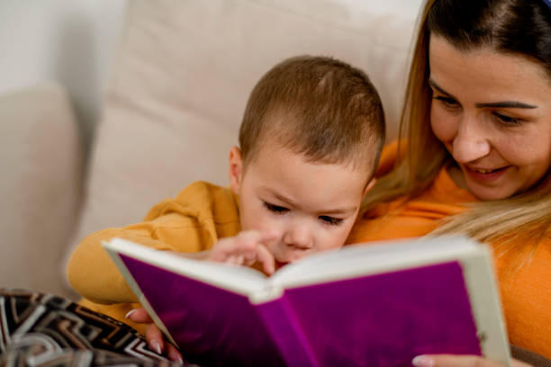 istock Young mum reading a story to her son in bed 1223092580