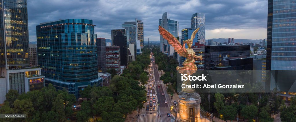 Front aerial view of the statue of the angel of independence on Reforma Avenue with chapultepec forest in the background Sculpture of the Angel of Independence Mexico Stock Photo