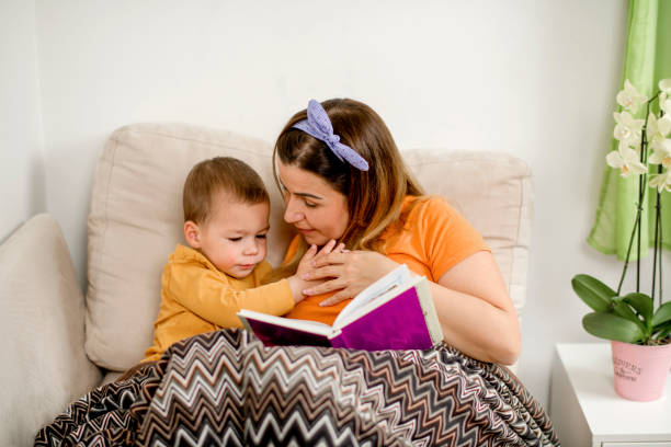 istock Young mum reading a story to her son in bed 1223093408