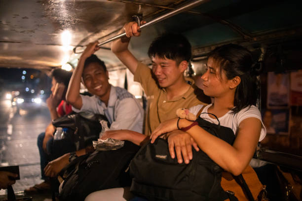 Young Asian friends talking in jeepney