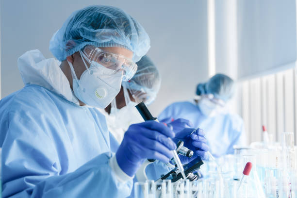 istock biochemical research scientist team working with microscope for coronavirus vaccine development in pharmaceutical research labolatory 1223093646
