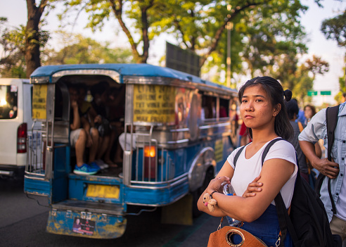 Young Asian woman waiting for a jeepney to come