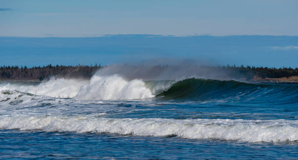 istock Waveas crashing on rocky shoreline 1223094762