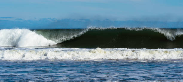 istock Waves carshing onto rocky shoreline 1223099067