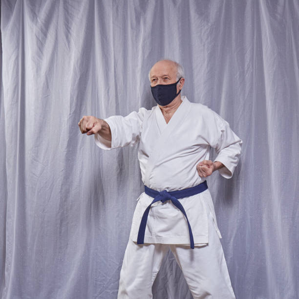 istock Old athlete trains formal karate exercises in self-isolation 1223100575
