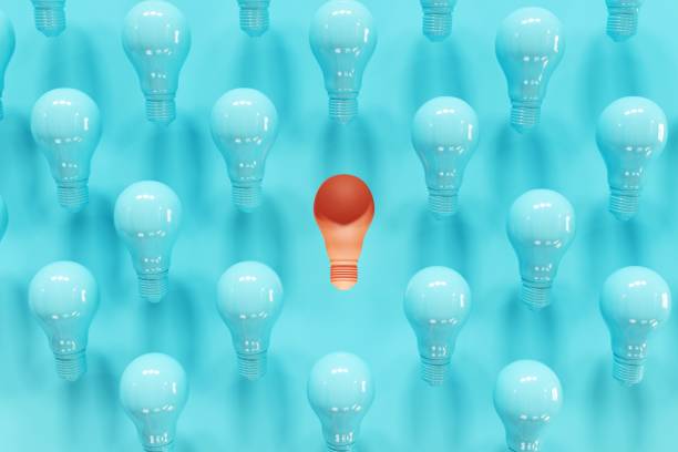 istock Outstanding Orange Light bulb slump Among blue light bulbs on blue background. 3D Render. Minimal Creative idea. 1223101892