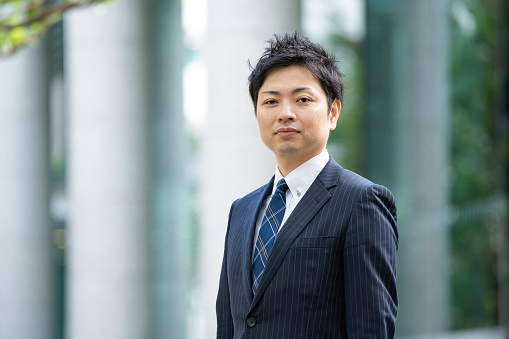 Portrait of Asian (Japanese) businessman on business street in Tokyo, Japan