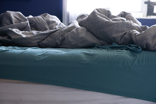 This is a photograph of an unmade messy bed during the Coronavirus Lockdown in Miami, Florida USA.