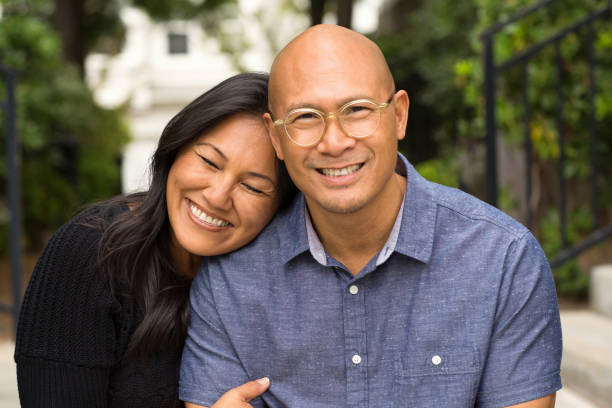 istock Happy Asian couple smiling and hugging outside. 1223107761