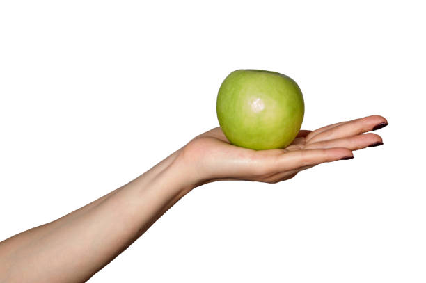 istock Green apple in woman hand. Isolated on white 1223107773