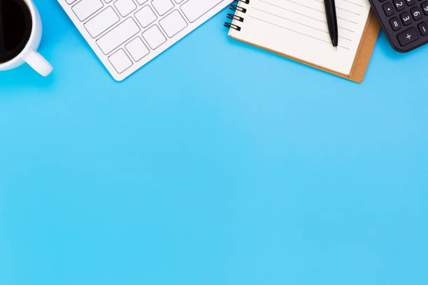 istock flat lay Office desk table of modern workplace with laptop on blue table, top view laptop background and copy space on black background, blue desk office with laptop, smartphone and other work supplies with mouse. 1223114202