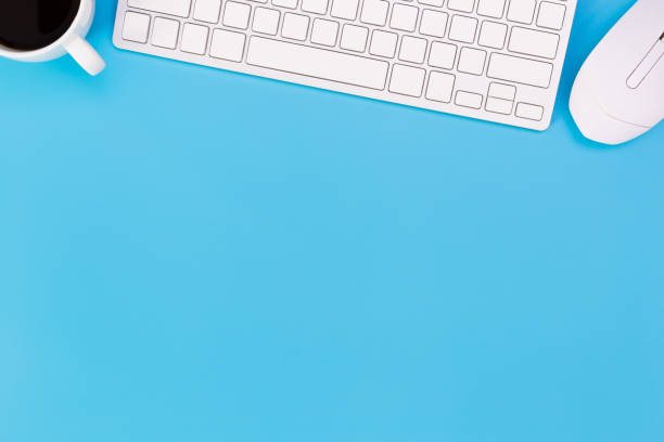 istock flat lay Office desk table of modern workplace with laptop on blue table, top view laptop background and copy space on black background, blue desk office with laptop, smartphone and other work supplies with mouse. 1223114212
