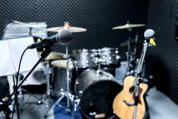 istock Professional condenser studio microphone, Musical Concept. recording, selective focus  microphone in radio studio, selective focus microphone and blur musical equipment guitar ,bass, drum piano background. 1223114279