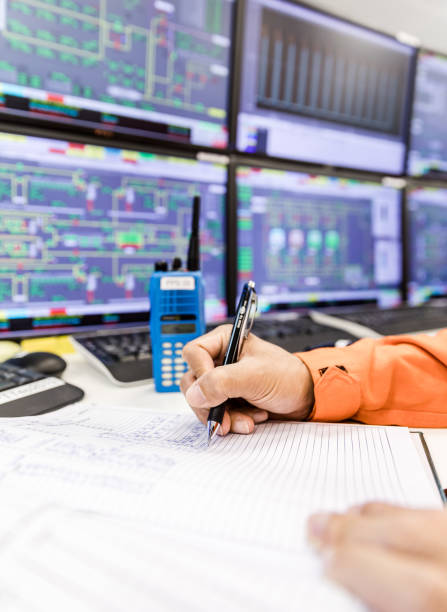 istock female hands with pen writing on notebook for report control panel in oil and gas process background. 1223114291