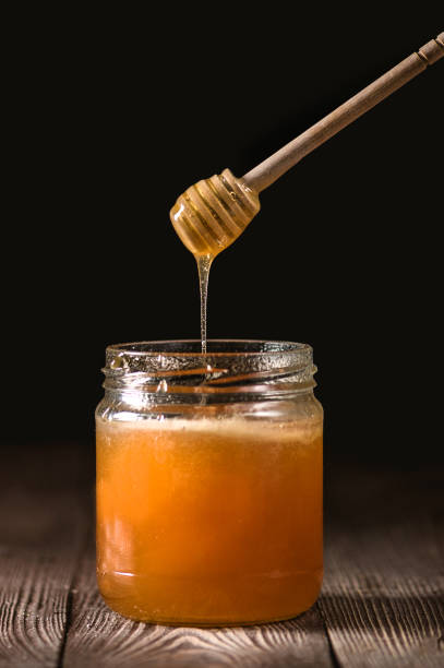 istock Honey with wooden honey dipper 1223116658