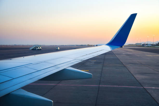 istock Airplane wing on the runway in the evening 1223116703