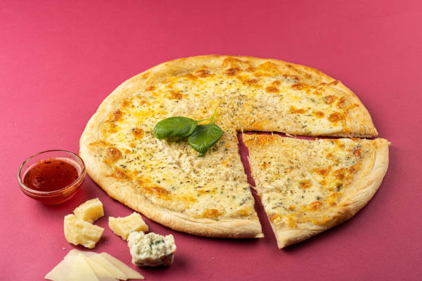 istock pizza close-up, isolated, against a colored background. whole pizza 1223118893