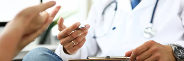 istock Therapeutist in clinic office receiving sick client 1223119920