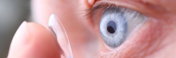 istock Man putting on soft contact lens 1223120032