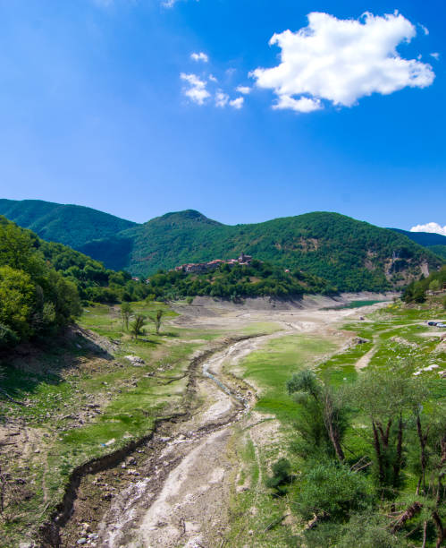 istock drought and temperature rise catastrophe, dry river and town without water. 1223120979
