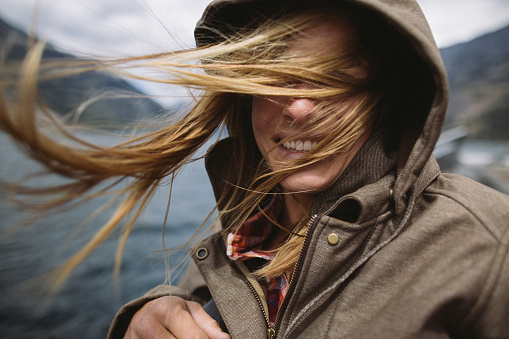 Beautiful smiling woman with her hair blowing in the wind
