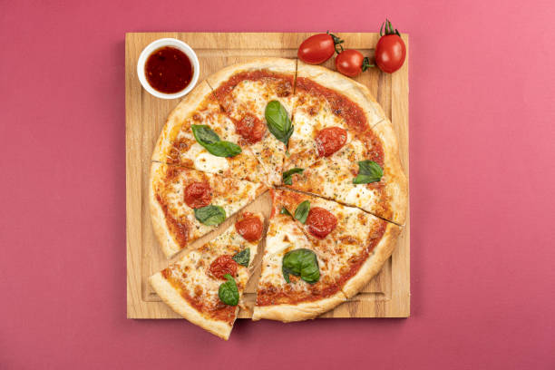 istock pizza close-up, isolated, against a colored background. whole pizza 1223121883