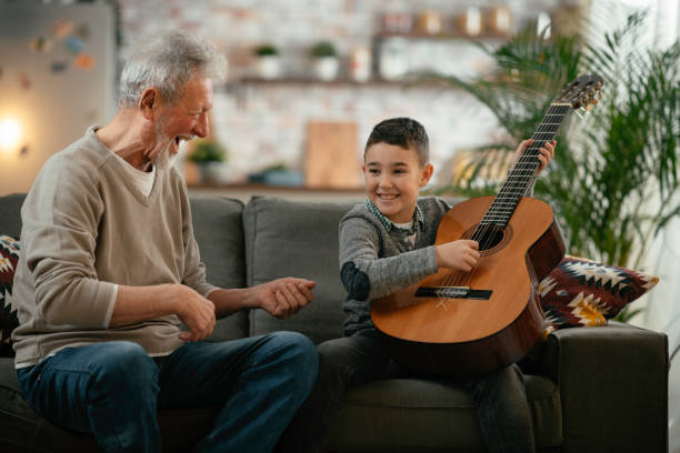 istock Grandfather and grandson playing guitar. 1223123088
