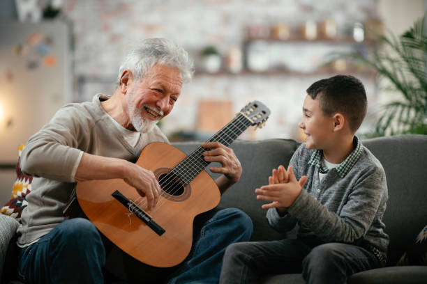 istock Grandfather and grandson playing guitar. 1223123097