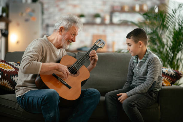istock Grandfather and grandson playing guitar. 1223123108
