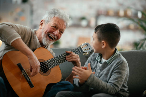 istock Grandfather and grandson playing guitar. 1223123123