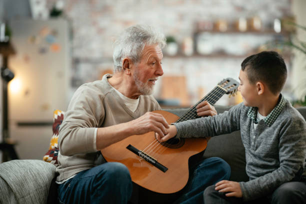 istock Grandfather and grandson playing guitar. 1223123125