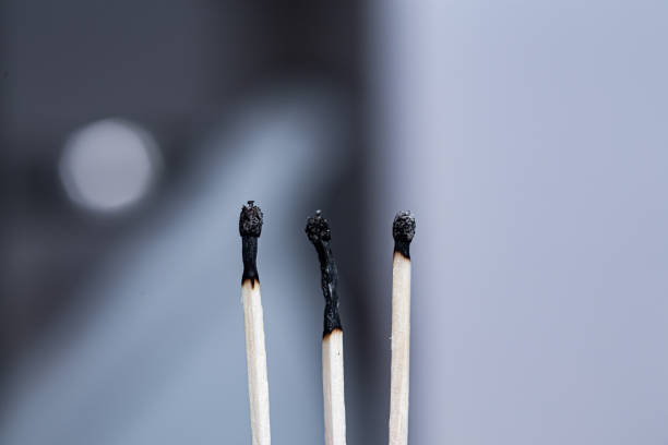 istock Three burnt black match sticks in a row close up still 1223125461