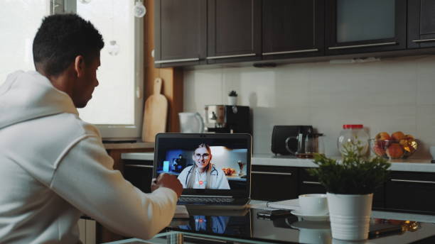 istock Black man making video consultation with female doctor on computer 1223128241