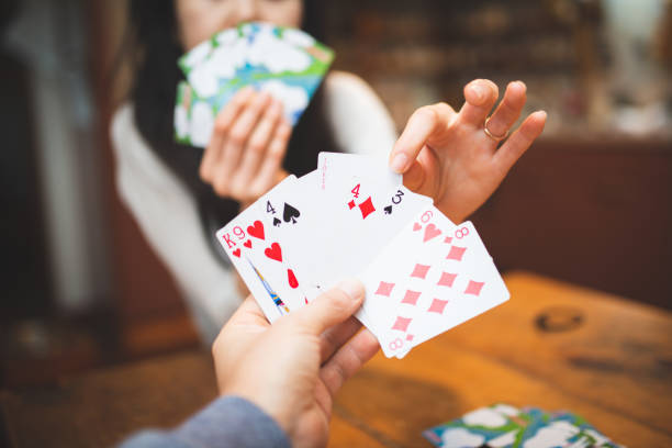 istock Couple playing cards at home 1223130992