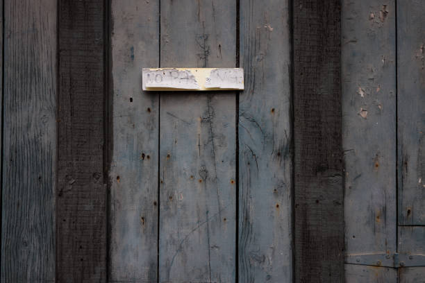 An old hand written No Parking sign.