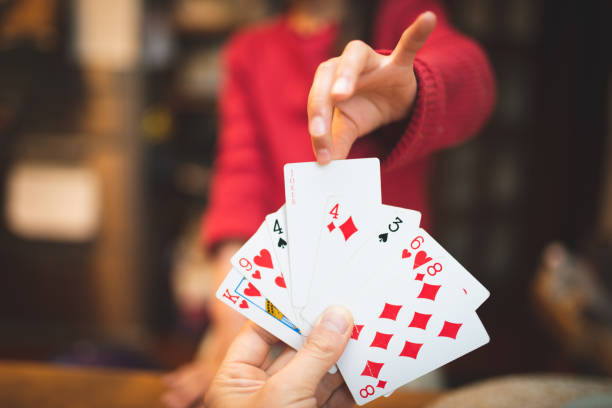 istock Parent and child playing cards at home 1223131528