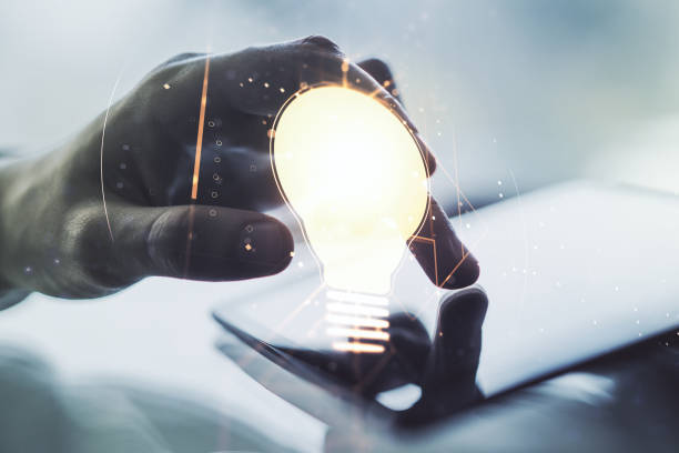 istock Creative light bulb illustration with finger presses on a digital tablet on background, future technology concept. Multiexposure 1223132018