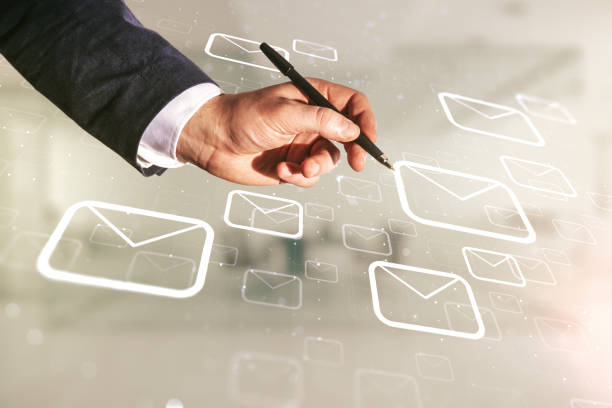 istock Male hand with pen working with abstract virtual postal envelopes sketch on blurred office background, e-mail and marketing concept. Double exposure 1223132834