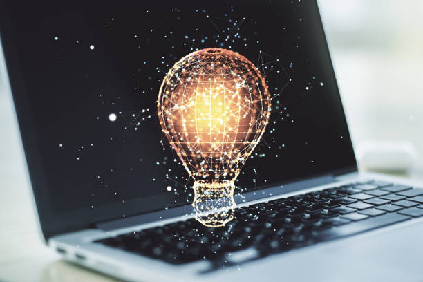 Double exposure of creative light bulb hologram on laptop background, research and development concept Double exposure of creative light bulb hologram on laptop background, research and development concept power energy development abstract stock pictures, royalty-free photos & images