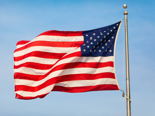 istock American flag on blue sky 1223134192