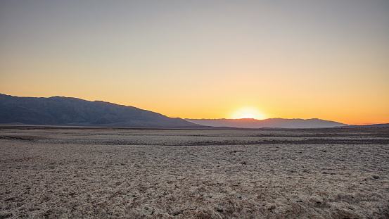 Moody Sunset Panorama of Death Valley Salt Basin in atmospheric twlight. Death Valley's Badwater Basin has the lowest elevation in North America at 282f below sea level. Death Valley National Park, Eastern California, USA, North America