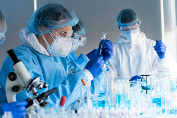 istock virus experts discover coronavirus covid 19 vacinne holding  syringe labelled coronavirus covid 19 in laboratory 1223136638