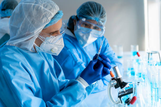 istock virus experts discover coronavirus covid 19 vacinne holding  syringe labelled coronavirus covid 19 in laboratory 1223136650