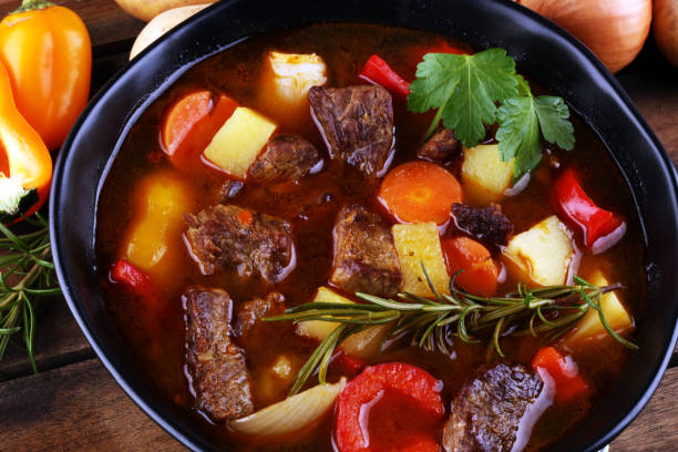 istock Meat stew with vegetables. Beef stew with potatoes, carrots and fresh herbs on table. 1223136783