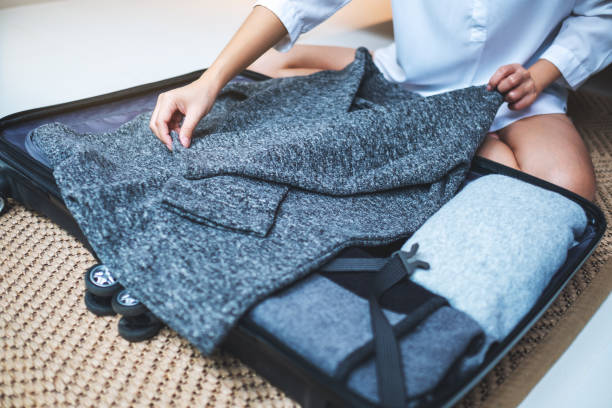 istock a woman packing luggage for a trip 1223136814