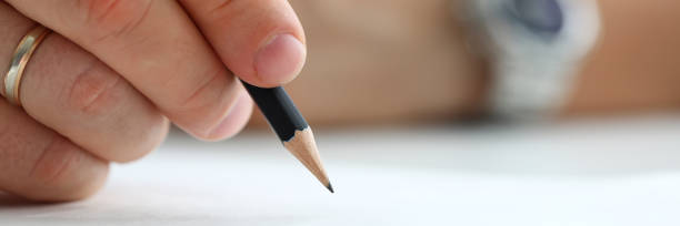 istock Male arm holding black simple pencil ready to draw 1223137045